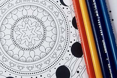 Image of a coloring page and colored pencils.